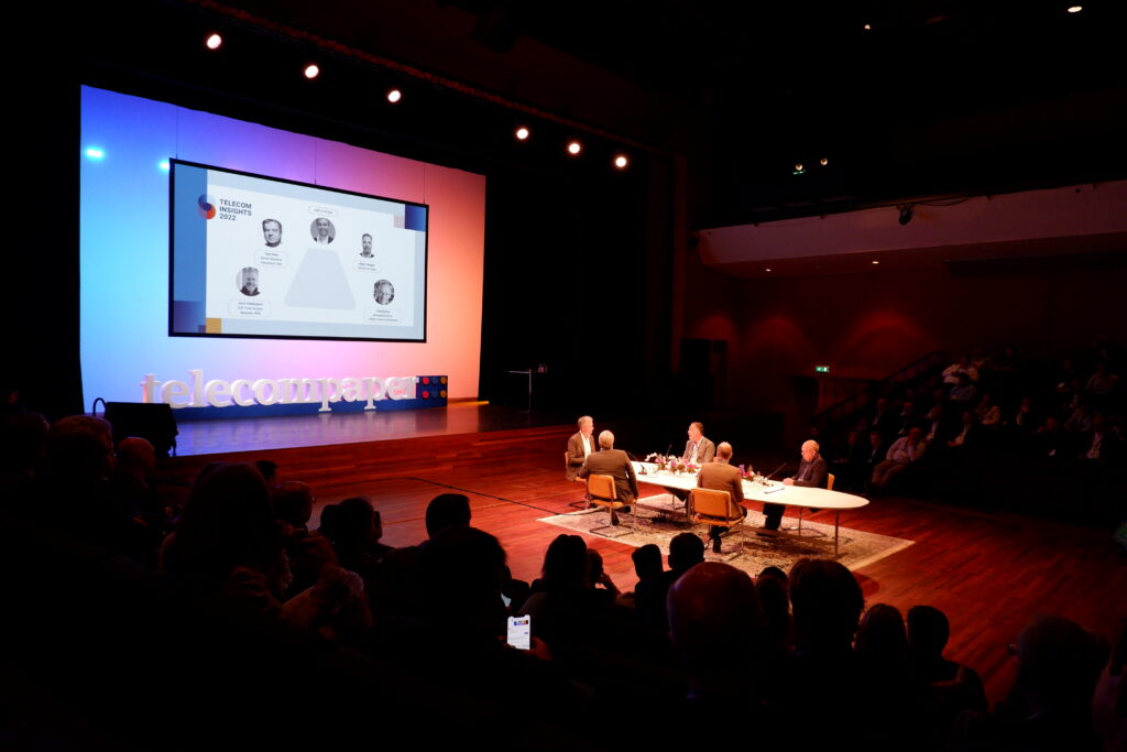 Telecom event for Cellnex with presenters seated at a table during their presentation.